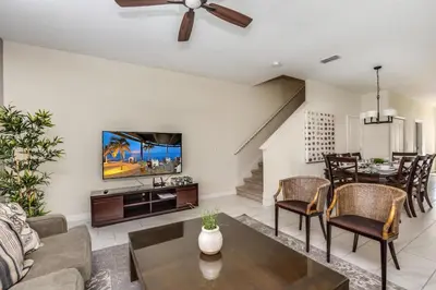 a living room with a couch and a table at Ev3097 - Lakeside Serenity Villa in Kissimmee
