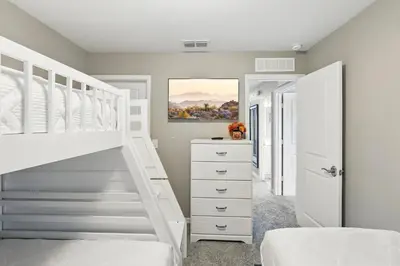 a bedroom with a white bunk bed and a staircase at Ev3115 - Sunset Bay Villa in Kissimmee