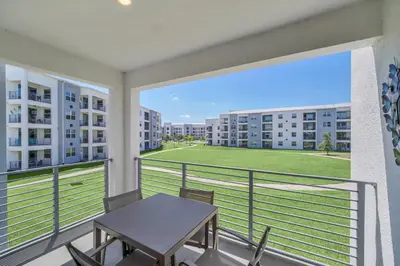 a balcony with a table and chairs in a apartment at Ev3180 Unit203 - Captains Cove Villa in Kissimmee