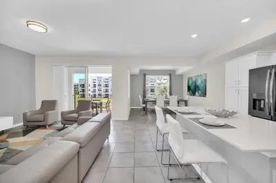 a living room with white furniture and a dining room at Ev3180 Unit203 - Captains Cove Villa in Kissimmee