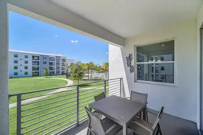 a balcony with a table and chairs and a view at Ev3180 Unit203 - Captains Cove Villa in Kissimmee