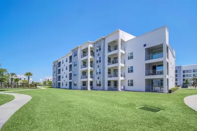 an apartment building with a lawn in front of it at Ev3180 Unit203 - Captains Cove Villa in Kissimmee