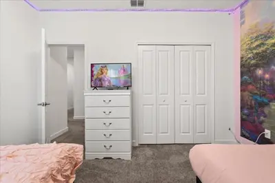 a bedroom with a white dresser with a tv on it at Ev4152 - Aventure Oasis in Kissimmee