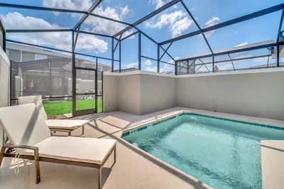 a swimming pool in a house with a glass ceiling at Ev4228 - Storey Retreat in Kissimmee