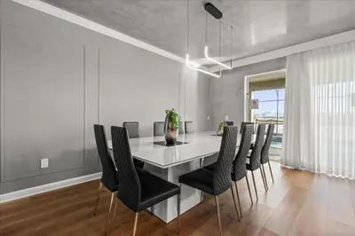 a dining room with a white table and black chairs at 4324Prolouge in Kissimmee