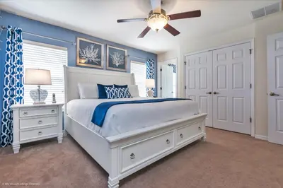 a bedroom with a white bed and a ceiling fan at Ev4550 - Bella Vista Haven in Kissimmee