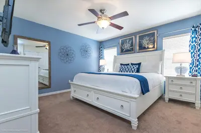 a blue bedroom with a bed and a ceiling fan at Ev4550 - Bella Vista Haven in Kissimmee