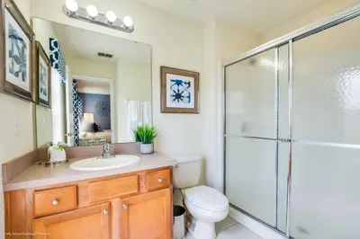 a bathroom with a shower and a toilet and a sink at Ev4550 - Bella Vista Haven in Kissimmee