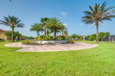a park with palm trees and a circular walkway at Ev4550 - Bella Vista Haven in Kissimmee