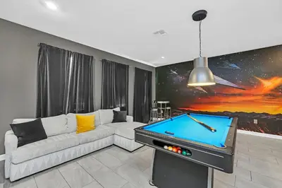 a living room with a couch and a pool table at Ev4569 - Storey Lake Serenity in Kissimmee
