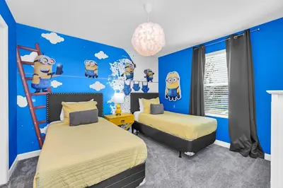 a bedroom with two beds and a blue wall at Ev4569 - Storey Lake Serenity in Kissimmee