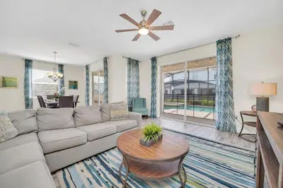 a living room with a couch and a table at Ev4710 - Regal Villa in Kissimmee