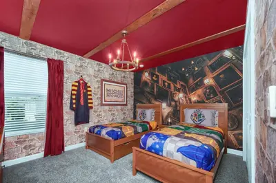 two beds in a room with a wall mural at Ev4710 - Regal Villa in Kissimmee