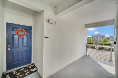 a room with a blue door and a balcony at Ev208 - The Storey Condo in Kissimmee