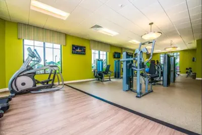 a gym with treadmills and elliptical machines at Ev4755 - Tranquil Haven Villa in Kissimmee