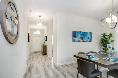 a dining room and living room with a table and chairs at Ev4778 - Paradise Cove Villa in Kissimmee