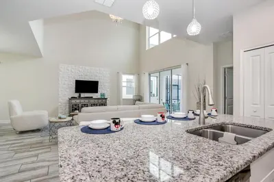 a kitchen with a sink and a living room at Ev4778 - Paradise Cove Villa in Kissimmee