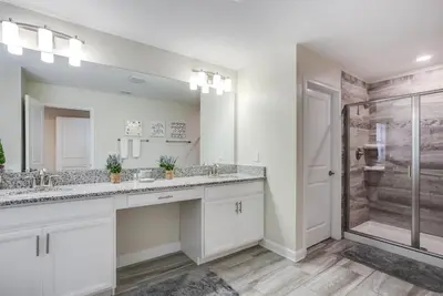a bathroom with two sinks and a shower at Ev4778 - Paradise Cove Villa in Kissimmee