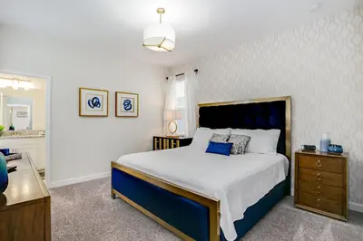 a bedroom with a blue and white bed and a dresser at Ev4778 - Paradise Cove Villa in Kissimmee