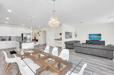 a kitchen and living room with a table and chairs at Ev4795 - Kings Oasis in Kissimmee