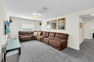 a living room with a brown leather couch in a room at Ev4795 - Kings Oasis in Kissimmee