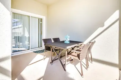 a table and chairs in a room with a window at Ev4796 - Palm Bay Retreat in Kissimmee