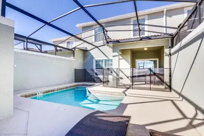 a swimming pool in the backyard of a house at Ev4796 - Palm Bay Retreat in Kissimmee