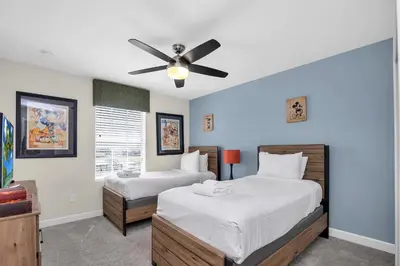 a bedroom with two beds and a ceiling fan at Ev4804 - Starlight Retreat in Kissimmee