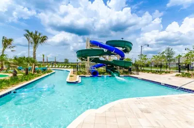 a water slide in a pool at a resort at 4811Ll Amazing 5 Bedroom 4 Bathroom in Kissimmee