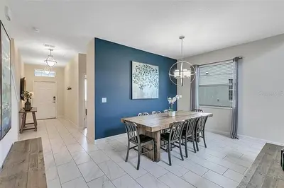 a dining room with a wooden table and chairs at Ev4815 - Regal Escape Villa in Kissimmee