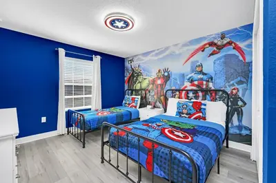 a bedroom with two beds and a superhero mural at Ev4876 - Charming Palms Villa in Kissimmee