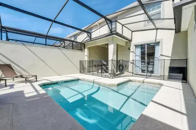 a swimming pool in the backyard of a house at Ev4876 - Charming Palms Villa in Kissimmee