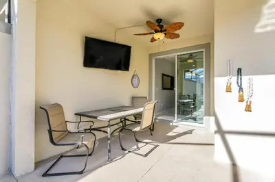 a dining room with a table and chairs and a ceiling fan at Ev4886 - Palm Haven Escape in Kissimmee