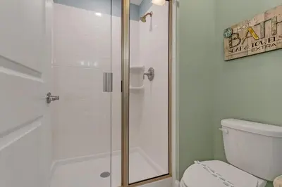 a bathroom with a shower with a white toilet at Ev4886 - Palm Haven Escape in Kissimmee