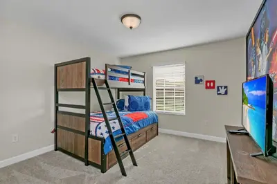 a bedroom with a bunk bed and a desk at Ev4886 - Palm Haven Escape in Kissimmee