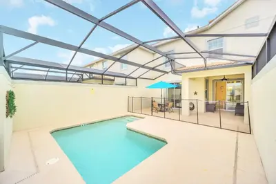 an indoor swimming pool in a house with a glass ceiling at Ev4927 - Beautiful Storey Lake in Kissimmee