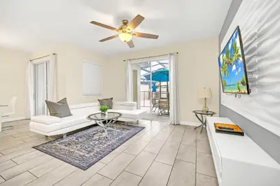 a living room with a couch and a ceiling fan at Ev4927 - Beautiful Storey Lake in Kissimmee