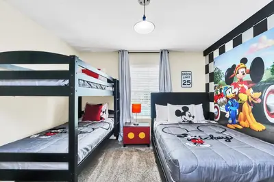 a bedroom with two bunk beds and a mural at Ev4987 - Raceway Retreat in Kissimmee