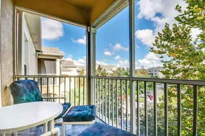 a balcony with a table and chairs and a window at Ev76604 - Windsor Condo in Orlando