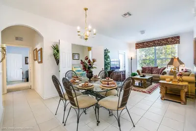 a dining room and living room with a table and chairs at Ev76604 - Windsor Condo in Orlando