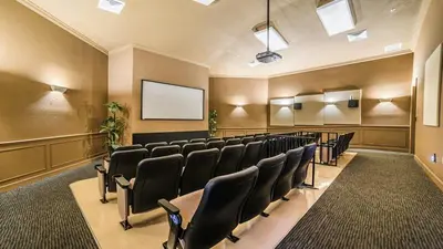 a conference room with black chairs and a screen at Ev76604 - Windsor Condo in Orlando