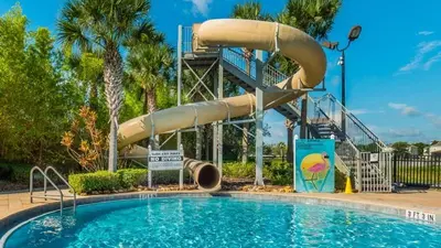 a swimming pool with a water slide in a resort at 7664Unit403 in Orlando