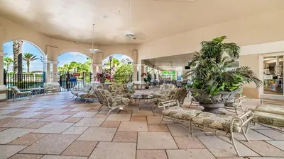 a large room with chairs and tables and plants at 7664Unit403 in Orlando