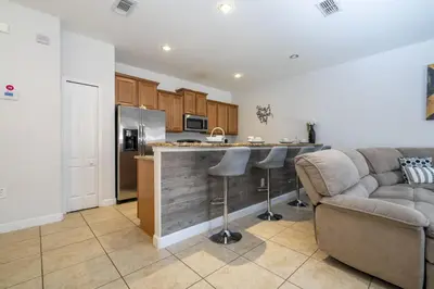a living room with a couch and a kitchen at Ev89270 - Paradise Manor in Kissimmee