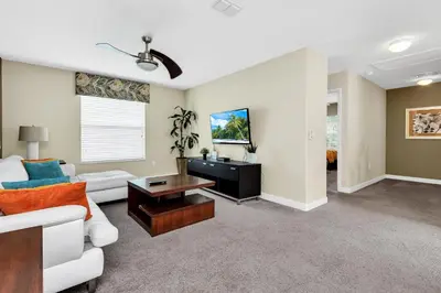a living room with a couch and a table at Ev8927 - Paradise Dream Retreat in Kissimmee