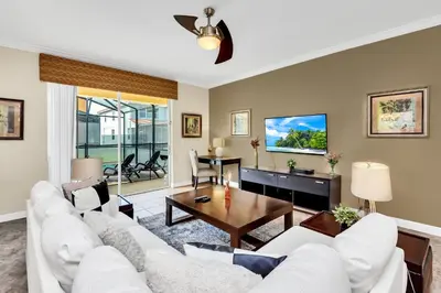 a living room with a white couch and a table at Ev8927 - Paradise Dream Retreat in Kissimmee
