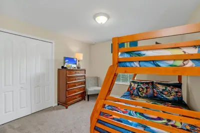 a bedroom with a bunk bed and a desk at Ev8950 - Paradise Oasis Villa in Kissimmee