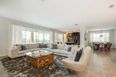a living room with a couch and a table at Ev9071- Solara Cove in Orlando