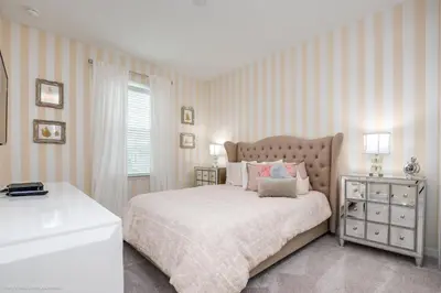 a bedroom with a bed and a dresser and a window at Ev9071- Solara Cove in Orlando
