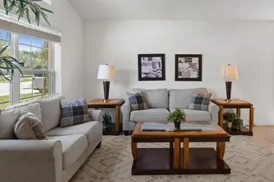 a living room with a couch and a coffee table at Casa 4Q c/ Piscina & Spa no Veranda Palms in Kissimmee